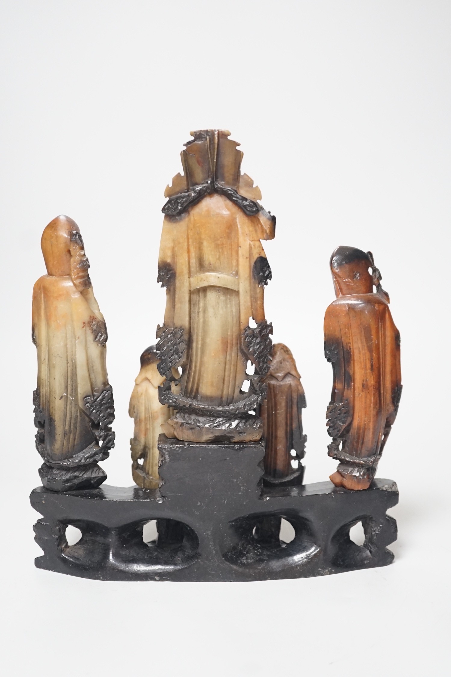 An early 20th century Chinese carved soapstone group of five deities on a rockwork base, 23cm